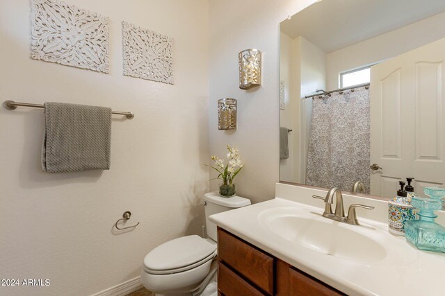 bathroom featuring toilet and vanity