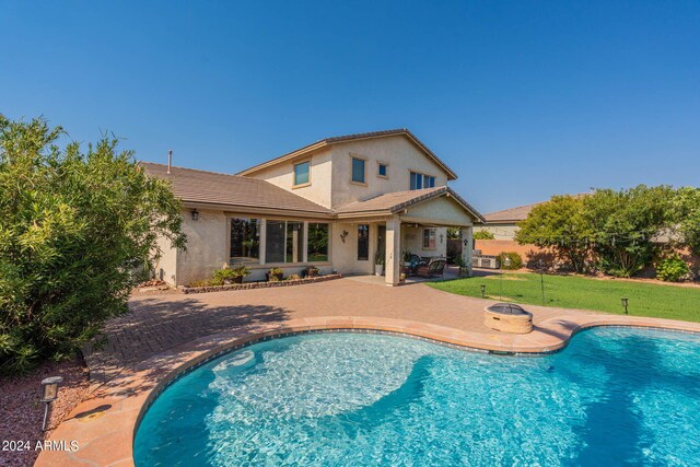 view of pool with a lawn and a patio area