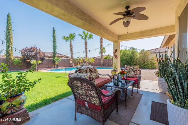 view of patio / terrace featuring ceiling fan, a fenced in pool, and an outdoor living space