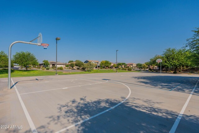 view of sport court featuring a yard