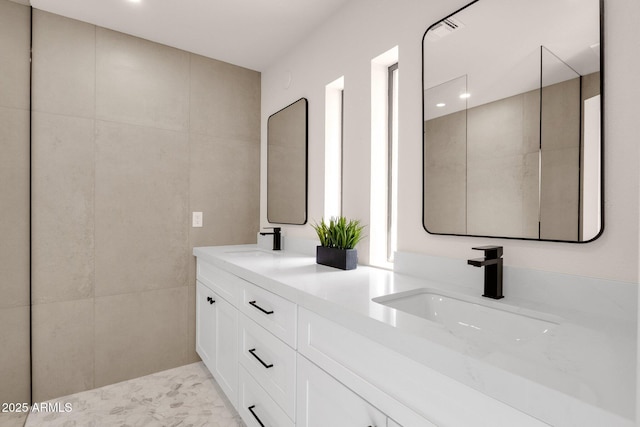 full bathroom with a sink and double vanity