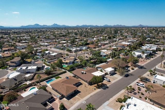 drone / aerial view featuring a residential view and a mountain view