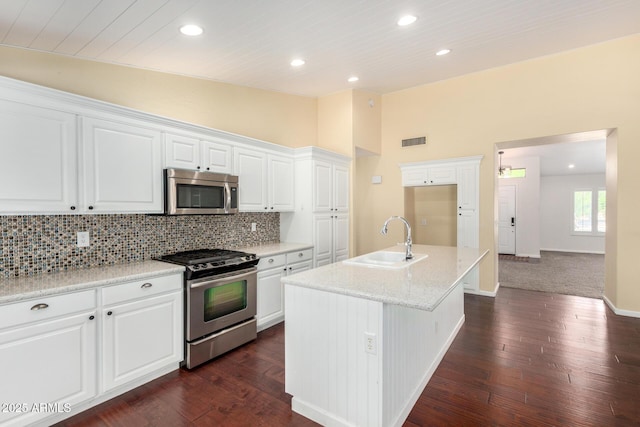 kitchen with stainless steel appliances, a sink, dark wood-type flooring, white cabinetry, and wood ceiling