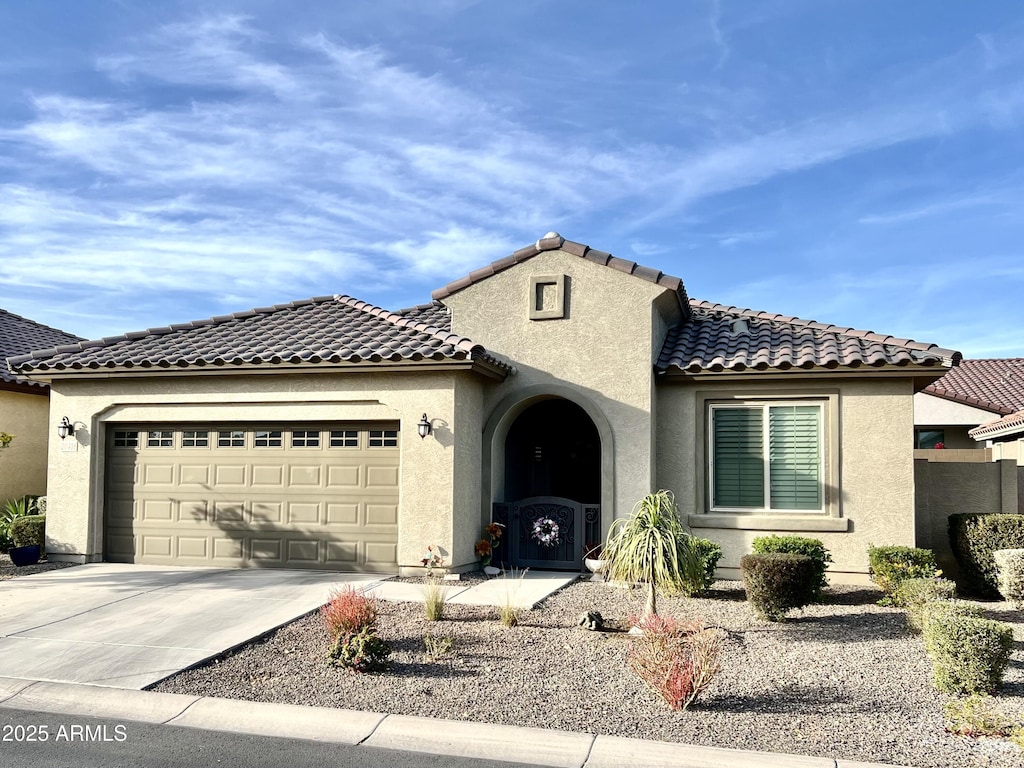 mediterranean / spanish home with a garage