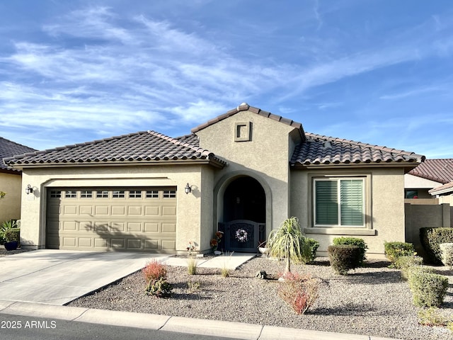 mediterranean / spanish home with a garage