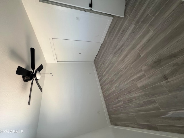 interior space with ceiling fan