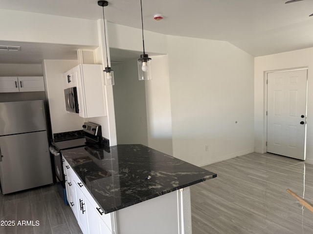 kitchen featuring visible vents, white cabinets, dark stone counters, and stainless steel appliances