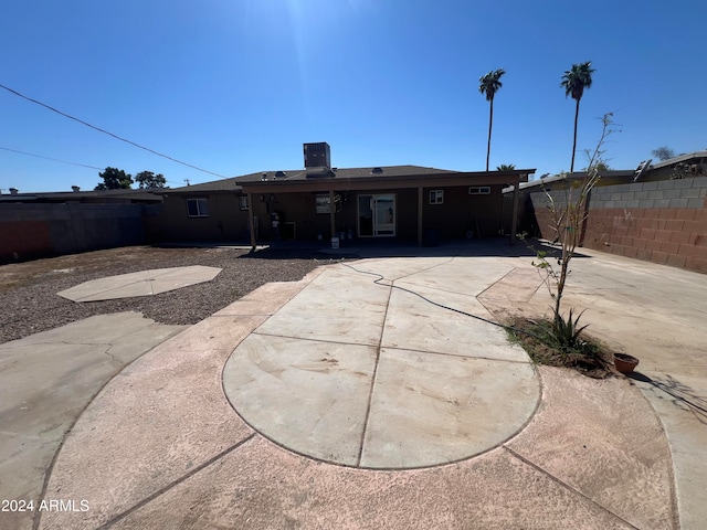 back of house featuring a patio area and central air condition unit