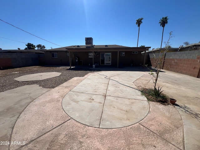 rear view of property featuring central air condition unit and a patio