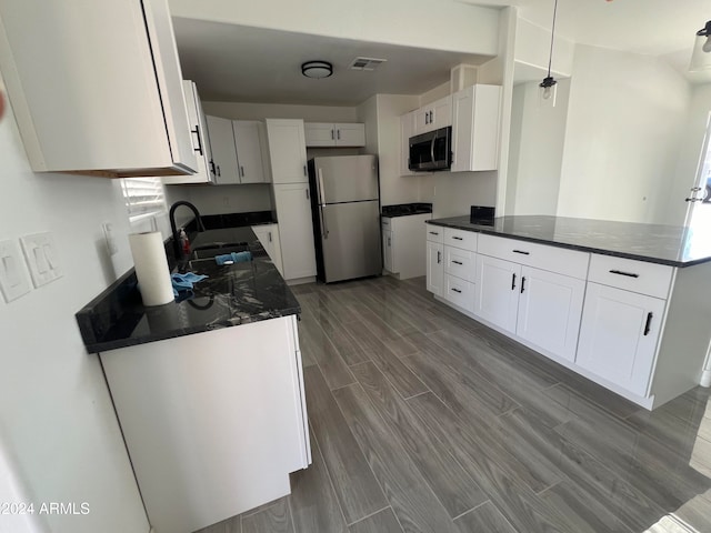 kitchen featuring white cabinets, sink, and appliances with stainless steel finishes