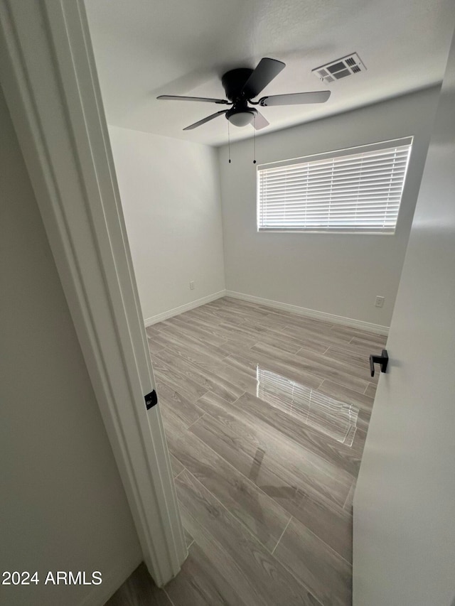 spare room featuring ceiling fan and light hardwood / wood-style floors