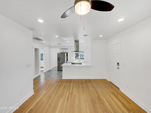 unfurnished living room with hardwood / wood-style floors and ceiling fan