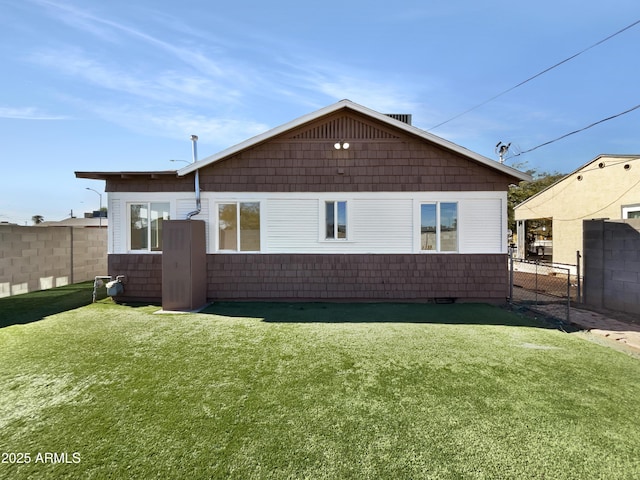 back of property featuring a lawn