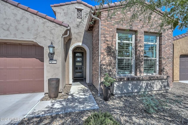 view of exterior entry featuring a garage