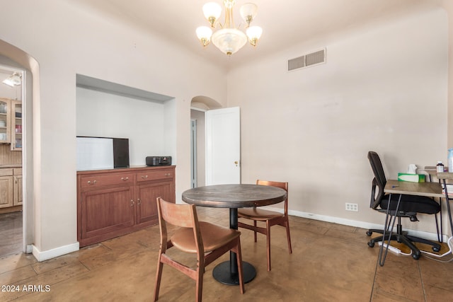 dining space with concrete floors and a notable chandelier