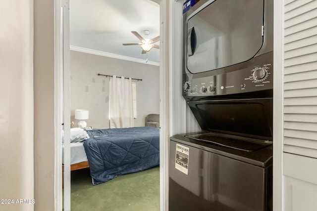 interior space featuring ceiling fan, crown molding, and stacked washer and clothes dryer