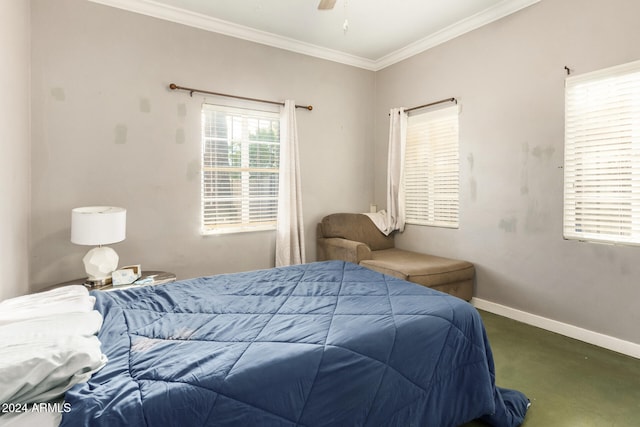 carpeted bedroom featuring crown molding and ceiling fan