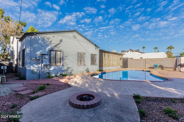 view of pool featuring a patio and a fire pit