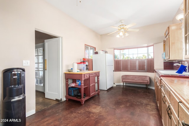 interior space featuring ceiling fan, white refrigerator, and sink