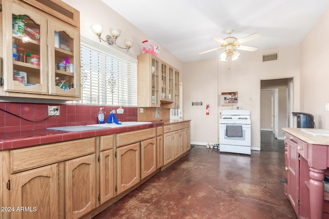 kitchen featuring tasteful backsplash, white range oven, tile counters, and ceiling fan