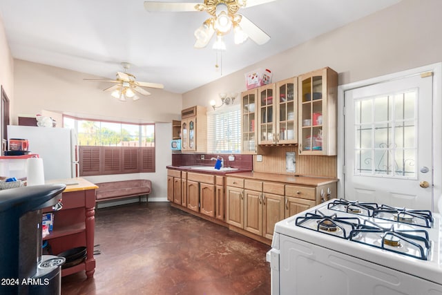 kitchen featuring decorative backsplash, white appliances, and sink