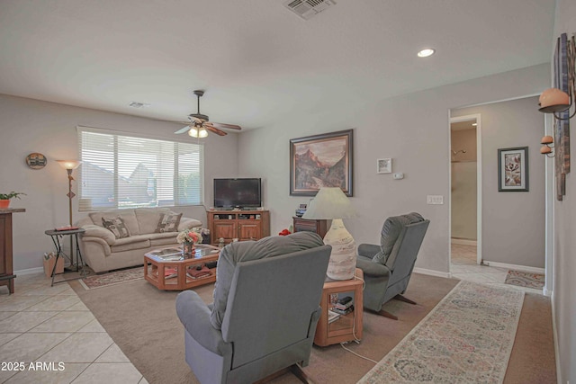 living room featuring a ceiling fan, visible vents, baseboards, and light tile patterned flooring