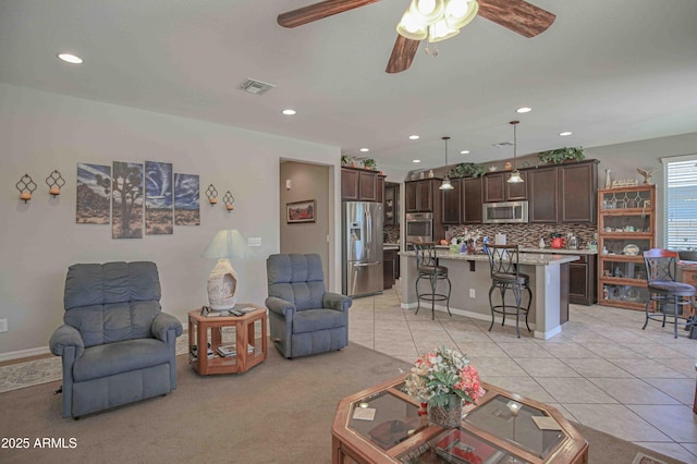 living room with light tile patterned floors, ceiling fan, visible vents, and recessed lighting