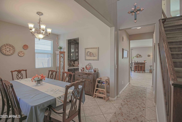 dining area with baseboards, stairway, a chandelier, and light tile patterned flooring