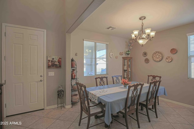 dining area with light tile patterned floors, baseboards, visible vents, and a notable chandelier