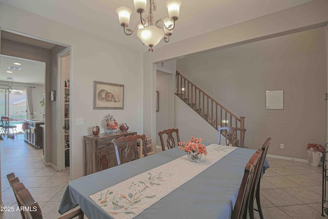 dining space featuring light tile patterned floors, stairway, baseboards, and an inviting chandelier