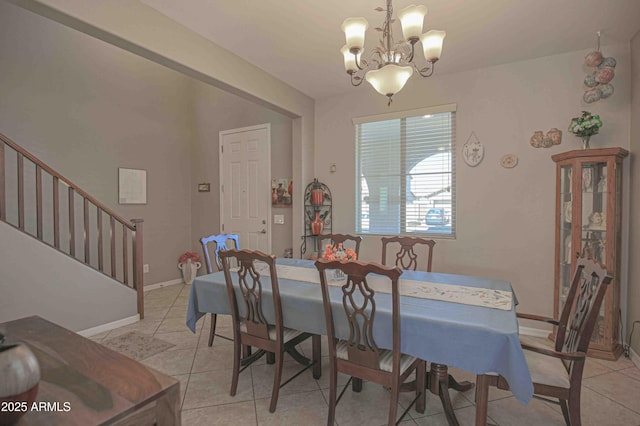 dining area featuring baseboards, stairway, a notable chandelier, and light tile patterned flooring