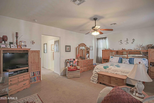 bedroom featuring visible vents, ceiling fan, and light carpet