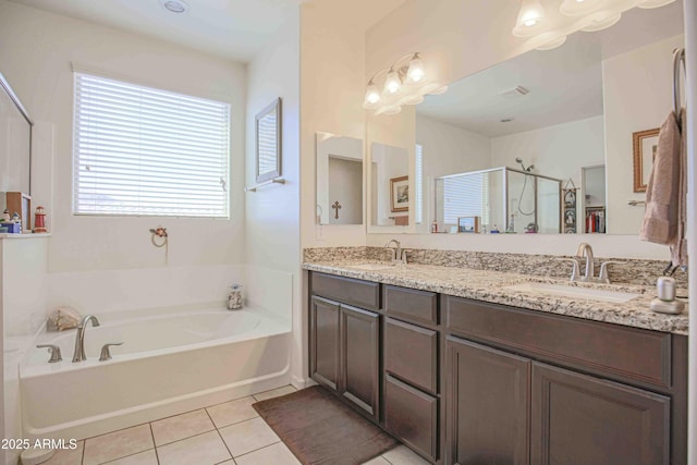 full bath featuring a sink, a shower stall, a bath, and tile patterned floors