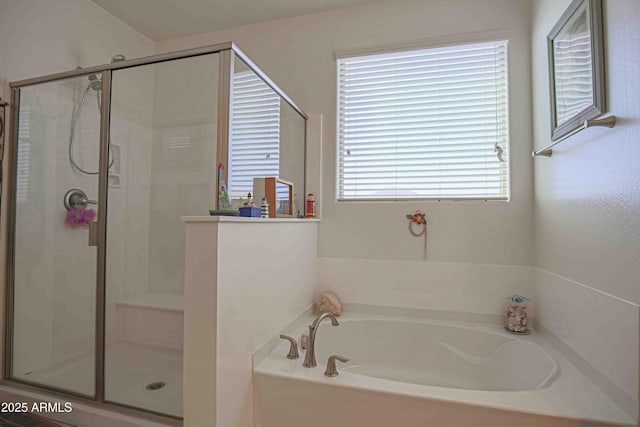 bathroom featuring a garden tub and a shower stall