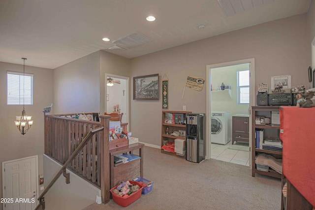 interior space with a chandelier, recessed lighting, an upstairs landing, washer / clothes dryer, and carpet