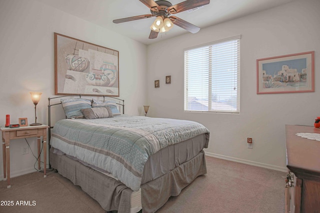 bedroom featuring light carpet, a ceiling fan, and baseboards