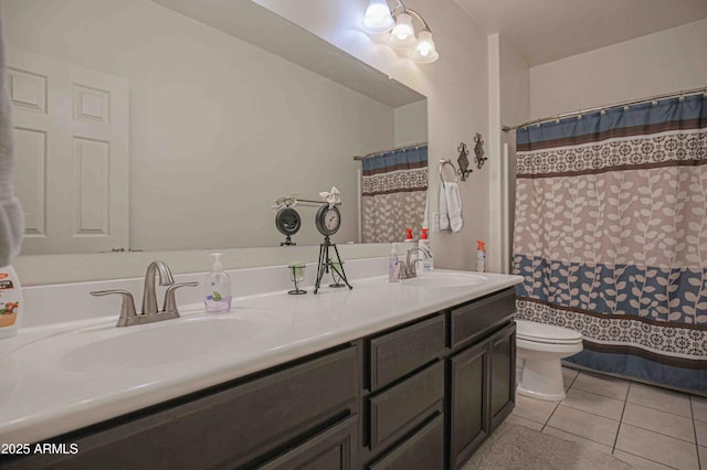 full bath featuring double vanity, tile patterned flooring, a sink, and toilet