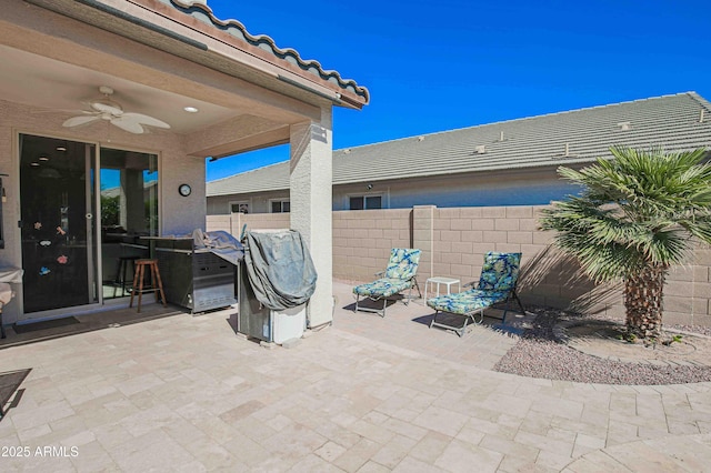 view of patio with ceiling fan and fence