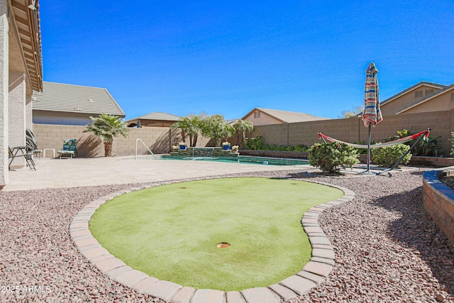 view of yard featuring a fenced in pool, a patio area, and a fenced backyard