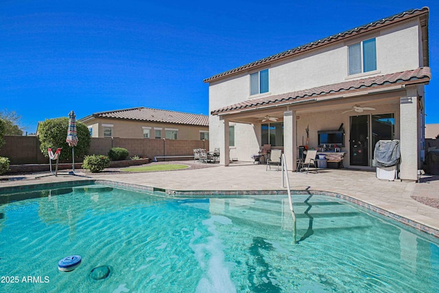 view of swimming pool with a ceiling fan, a patio area, a fenced backyard, and a fenced in pool