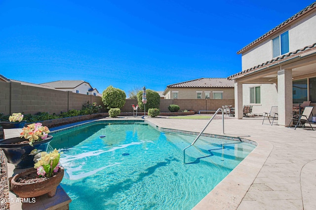 view of swimming pool featuring a patio area, a fenced backyard, and a fenced in pool