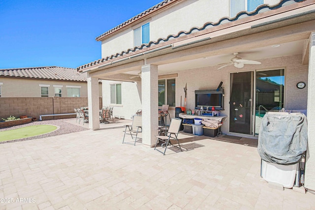 view of patio / terrace with a ceiling fan, outdoor dining area, and fence