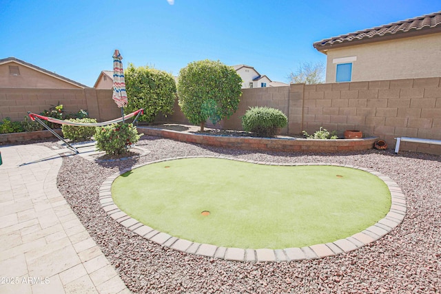 view of yard featuring a patio area and a fenced backyard