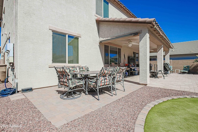 view of patio / terrace featuring ceiling fan, outdoor dining area, and fence