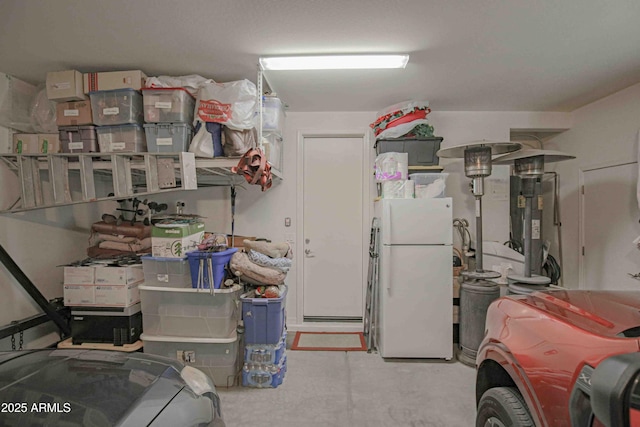 garage with heating unit and freestanding refrigerator