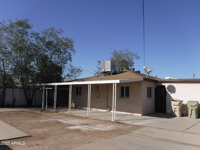 back of property with a patio area and central AC