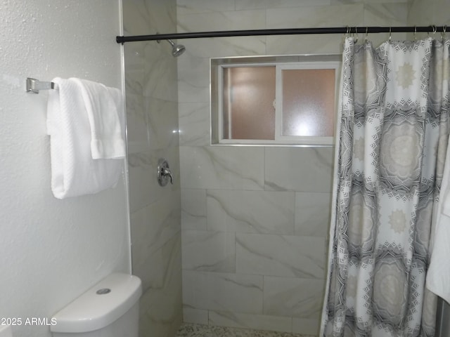 bathroom featuring curtained shower and toilet