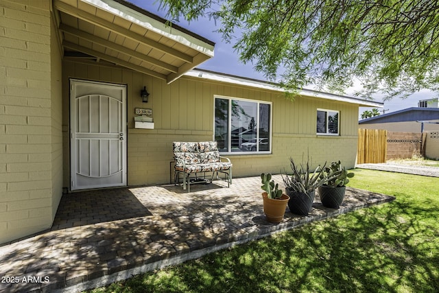 308 E Ln Jolla Dr, Tempe, AZ 85282 - view of exterior entry with concrete block siding and a patio