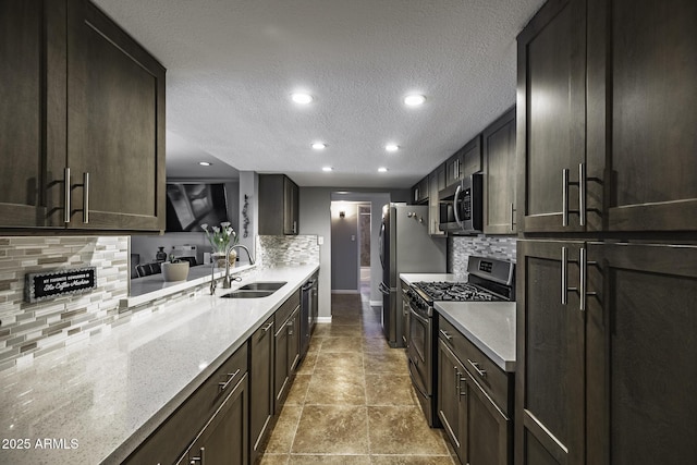 308 E Ln Jolla Dr, Tempe, AZ 85282 - kitchen featuring appliances with stainless steel finishes, a sink, backsplash, a textured ceiling, and baseboards