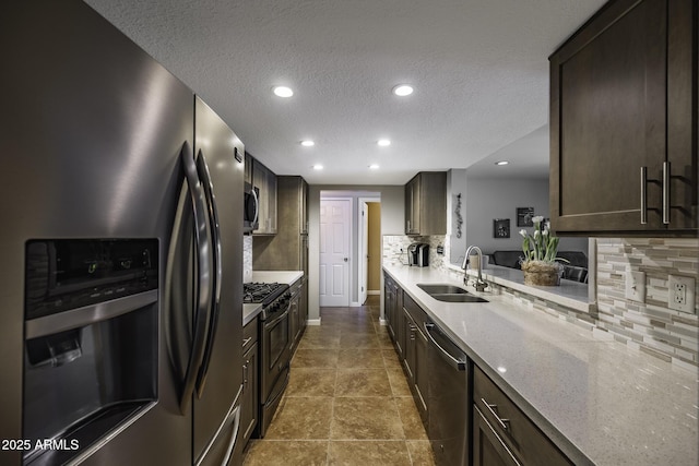 308 E Ln Jolla Dr, Tempe, AZ 85282 - kitchen with stainless steel appliances, a sink, decorative backsplash, a textured ceiling, and light stone countertops